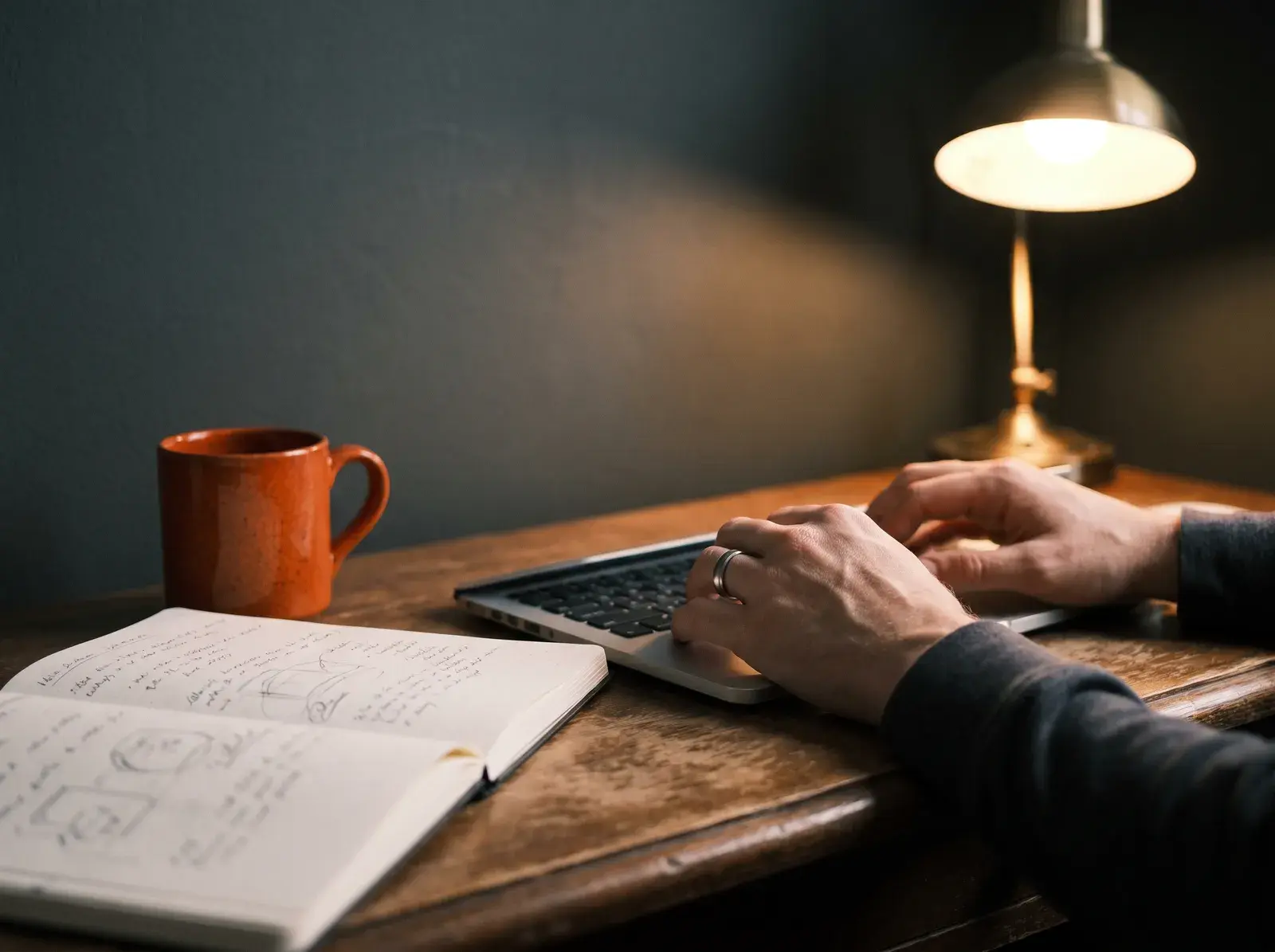 Writer drafting at a desk with interview notes